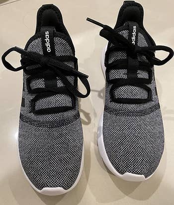 a top-down view of the knit sneakers in dark gray with black laces 
