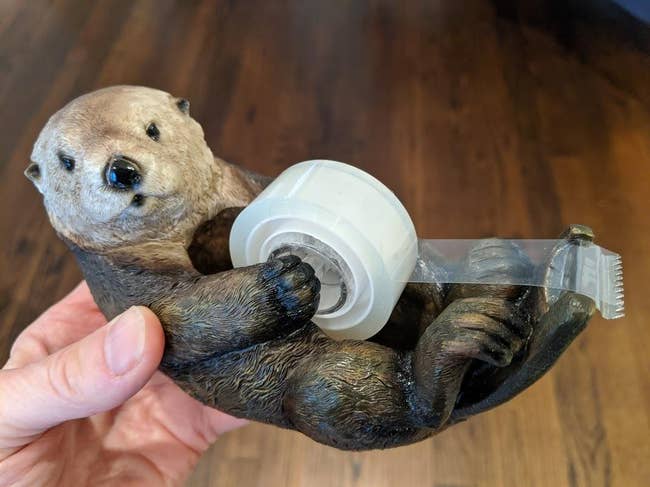 the tape dispenser that looks like an otter holding a roll of tape