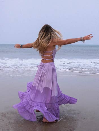 a reviewer spinning in the purple dress