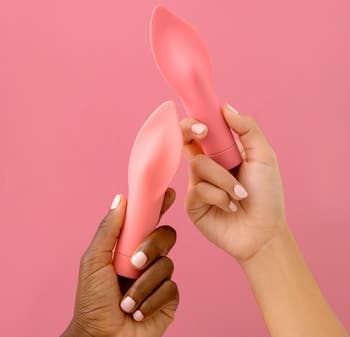 Models holding red flame-shaped vibrator