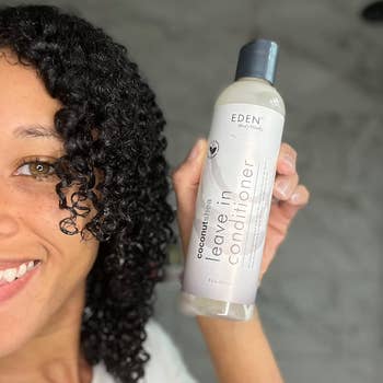 reviewer holding product and showing off curly hair