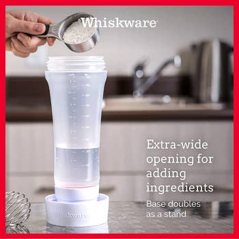 A model pouring ingredients into the batter mixer while it sits in its base
