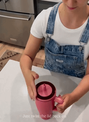 Person showing the leakproof capabilities of the BruMate