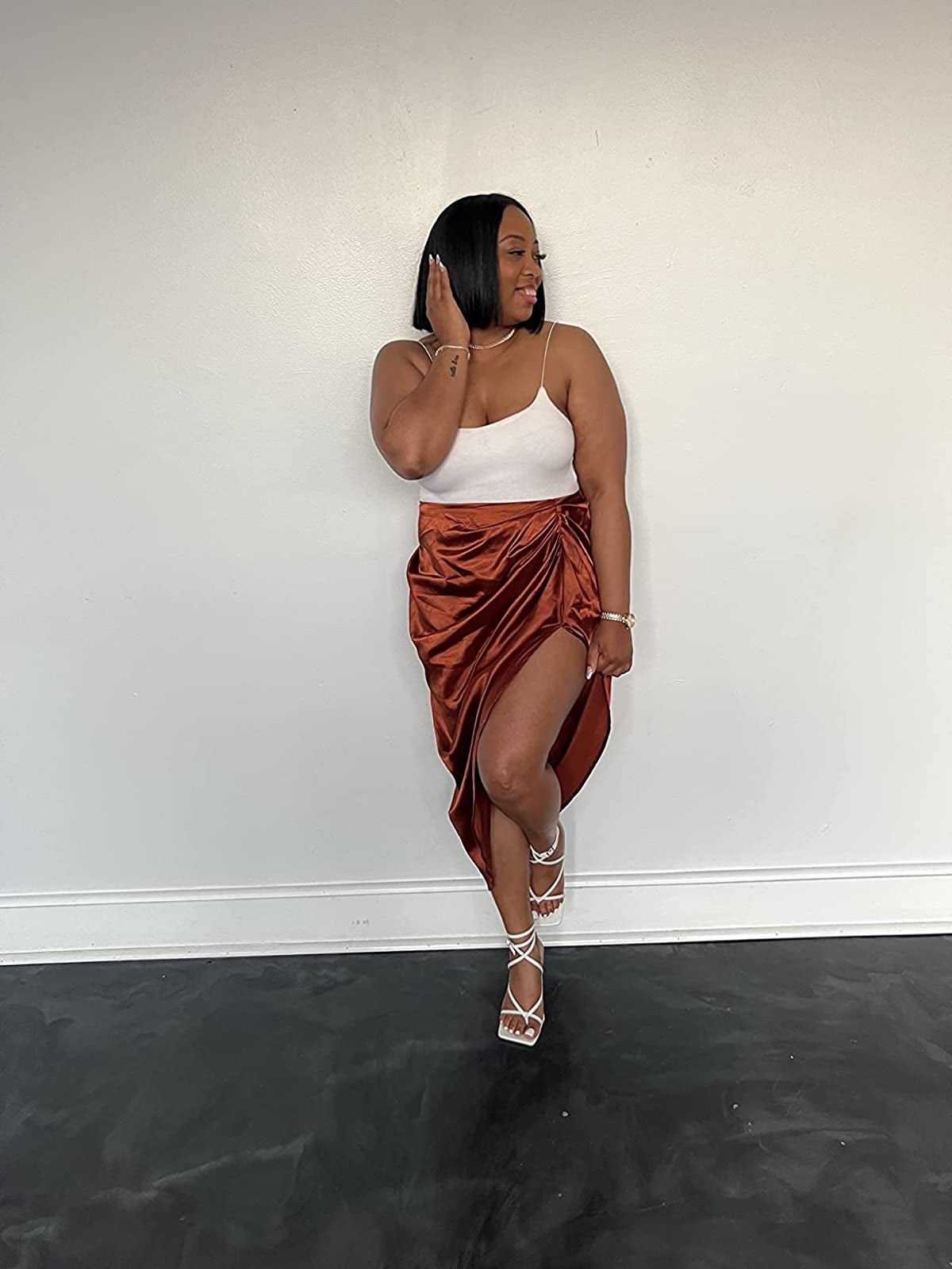 reviewer wearing the skirt in bronze