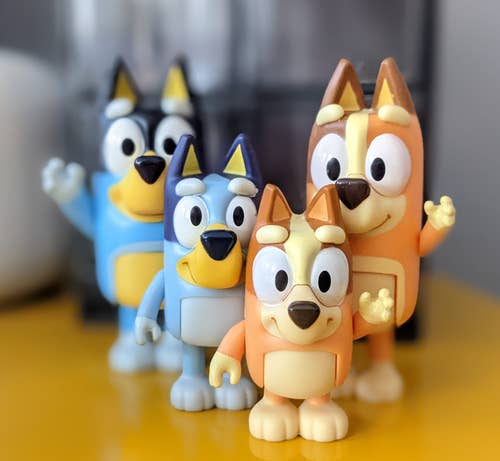 four dog figurines with moving parts photographed by a reviewer