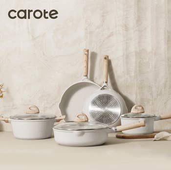 Set of Carote cookware connected  a room  counter, including pots and pans with woody  handles, suitable for location  cooking enthusiasts