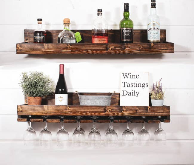 two wood wine racks holding an assortment of wine glasses, bottles, and decorative objects