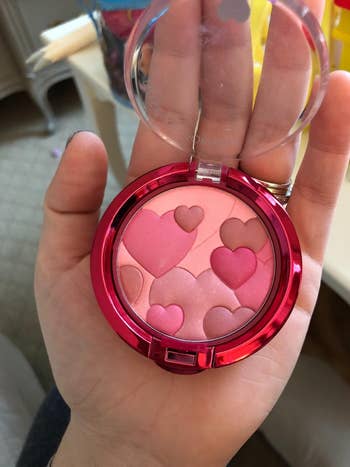 image of reviewer holding up the rose blush palette