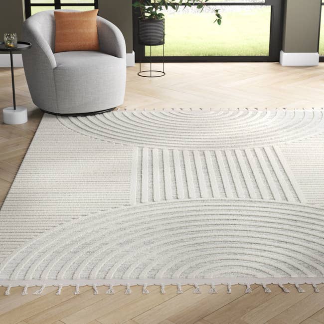 a product shot of the cream rug in a living room 