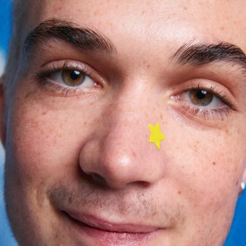 A yellow star shaped pimple patch on a model's nose 