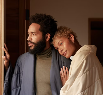 couple both wearing the wraps in different colors while hugging