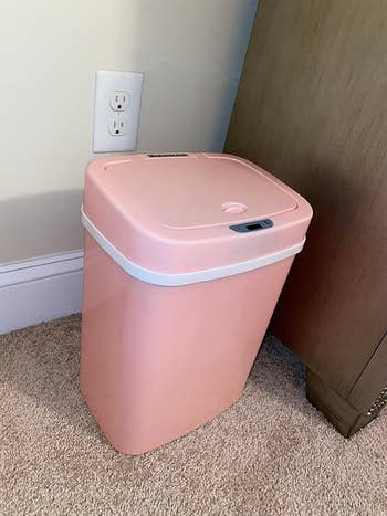 The pink trash can closed