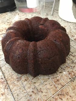 Bundt cake cooling on a wire rack on a kitchen counter