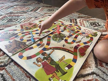 A vintage Candy Land board laid on a floor 