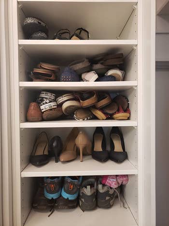 A reviewer's closet filled with shoes piled on top of each other