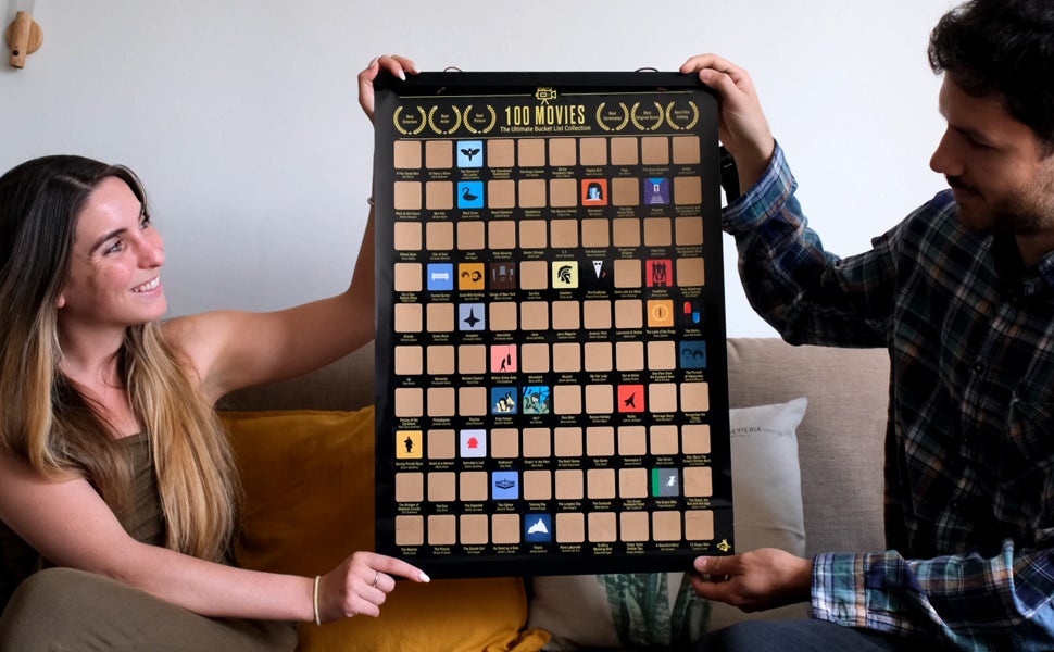 two models holding the poster with 100 scratch offs and some scratch offs revealing the movies