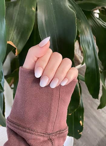 reviewer wearing white ombre round nails