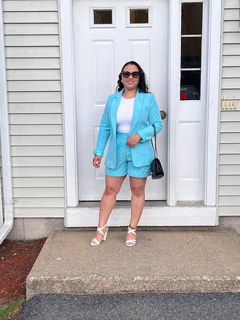 reviewer posing in the turquoise set