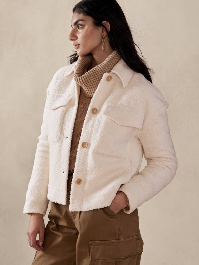 model in white cropped collared jacket with large front chest pockets 