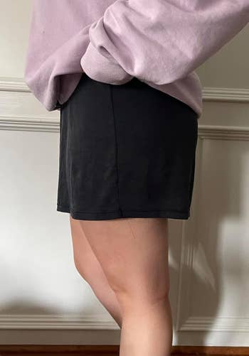 a reviewer showing the flowy shorts from the side