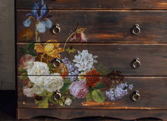 A dresser with floral rub on decals