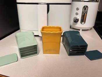 Three different colored cup slicers on a table