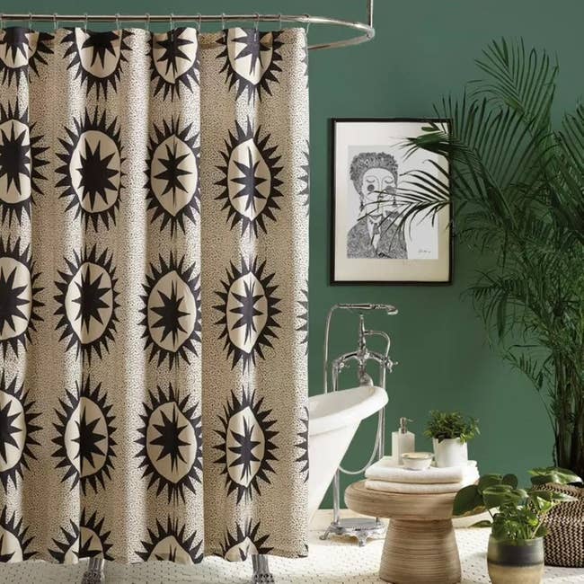 a bath  setup with a printed ablution  curtain
