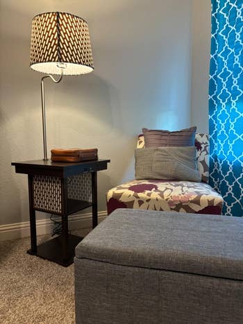 reviewer's speechmaking  nook with a patterned armchair, broadside  array  and attached lamp