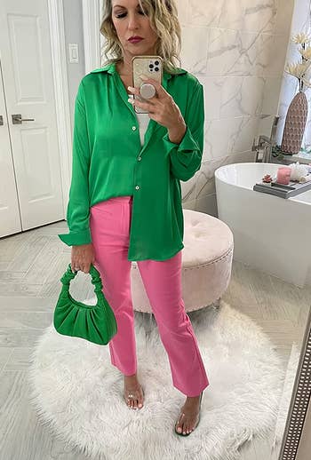 a reviewer taking a mirror selfie with the green bag