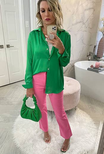 a reviewer taking a mirror selfie with the green bag