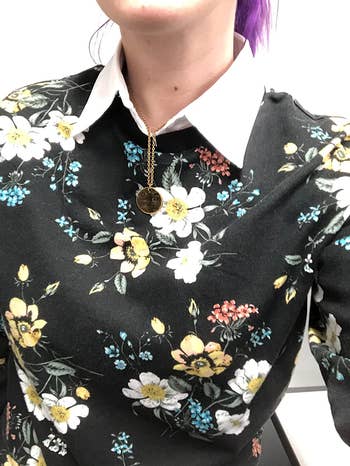 Closeup of reviewer wearing the collar with a floral shirt 
