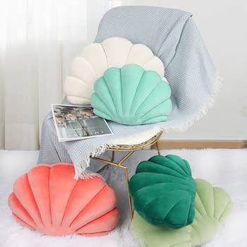 The pillows in various colors on a chair and on the floor near the chair