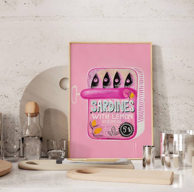 Framed artwork featuring a sardine tin labeled