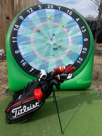 Golf target game with inflatable dartboard and golf ball darts