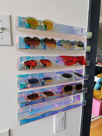 a review uses the six iridiscent wavy-edged shelves for holding sunglasses