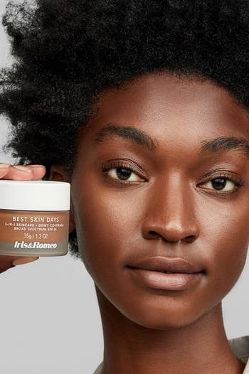 model wearing and holding tinted moisturizer in shade 11