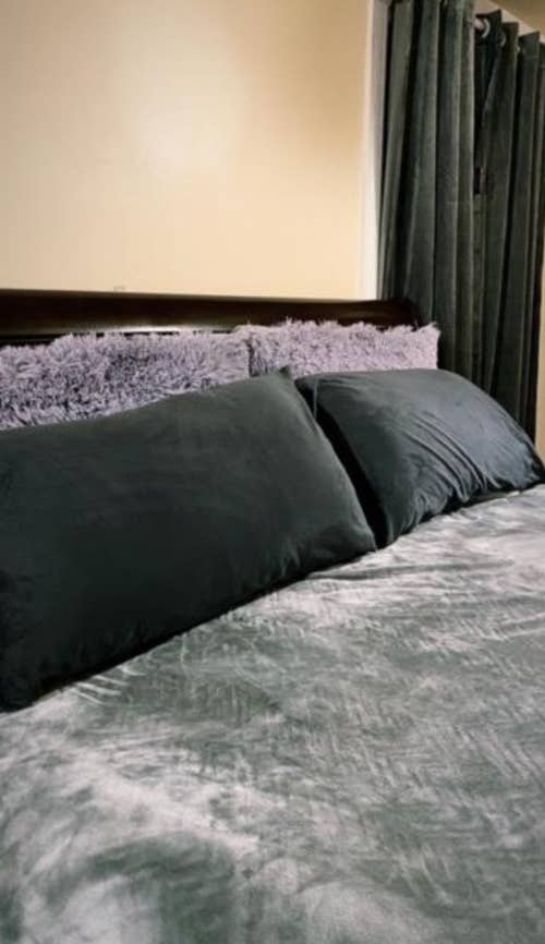 a reviewer's bed with the velvet pillowcases in charcoal grey