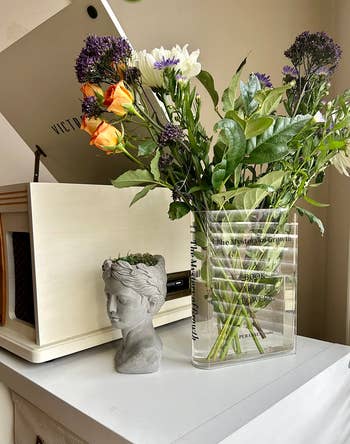 reviewer's book flower vase with flowers coming out of it