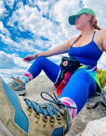 Buzzfeed writer outside hiking, wearing bright blue tank top and leggings