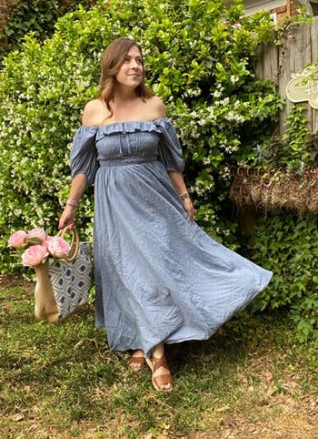 reviewer wearing dress standing in a garden