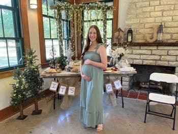 a reviewer wearing a square-neck maxi dress in sage