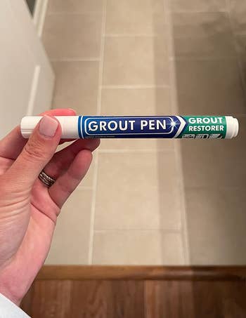 reviewer holding the grout pen