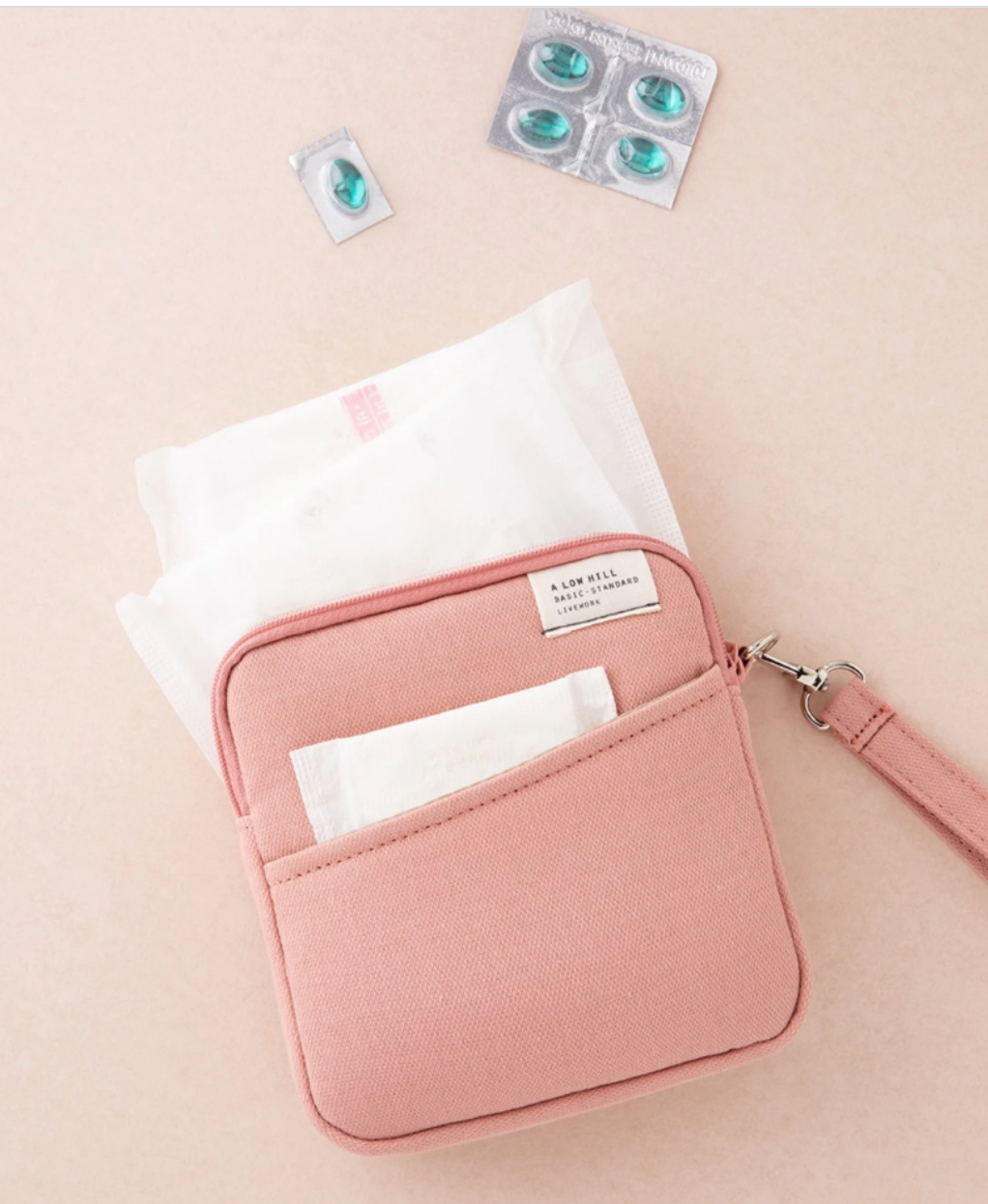 A small pink zippered pouch with a front pocket 
