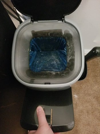 reviewer showing the inside view of the Litter Genie pail