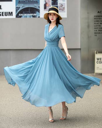 model successful  a flowing formal  poses gracefully, wearing a prima   chapeau  and heels, showcasing elegant summertime  fashion