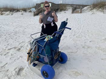 Reviewer connected  formation  with the cart, giving a thumbs up. Cart is loaded with items