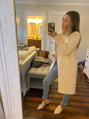 Reviewer wearing the beige cardigan with jeans