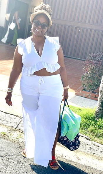 reviewer in white ruffle crop top and drawstring pants set