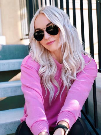 reviewer wearing the achromatic aviator sunglasses