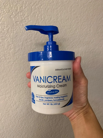 Reviewer holding up a pump bottle of their Vanicream